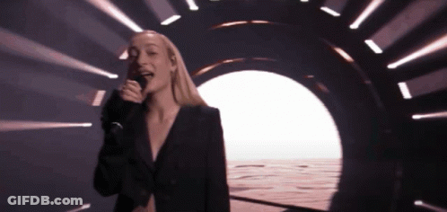 Woman Sings Into Microphone In Front Of Tunnel GIF