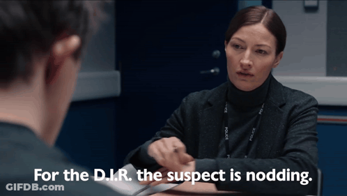 Woman Sits At Table And Says For The D.I.R. The Suspect Is Nodding GIF