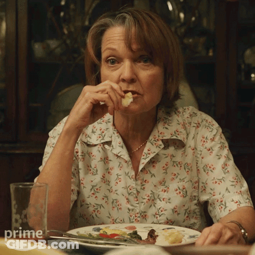 Woman Sits At Table With Plate Of Food And Prime Water Glass GIF