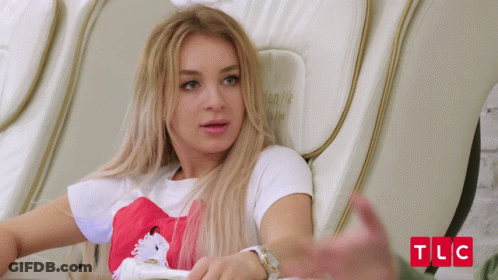 Woman Sits In Chair With TLC Written In Red GIF