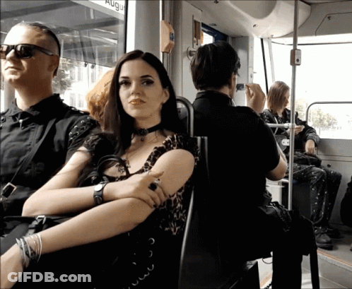 Woman Sits On Bus With Sign Saying Aug GIF