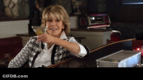 Woman Sitting At Bar Holding Martini GIF