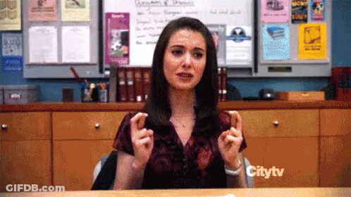 Woman Sitting At Desk In Front Of Citytv Sign GIF