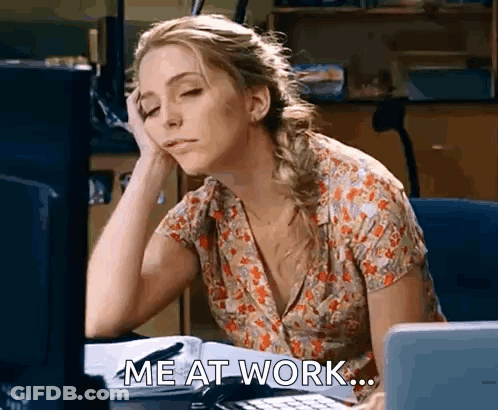 Woman Sitting At Desk With Hand On Forehead GIF