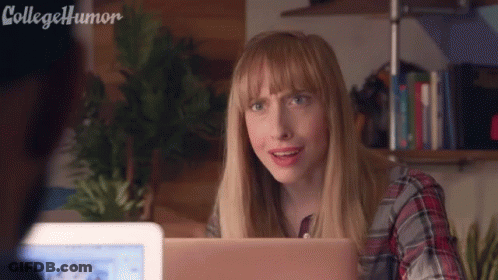 Woman Sitting At Desk With Laptop Making Funny Face GIF