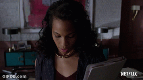 Woman Sitting At Desk With Netflix Logo GIF