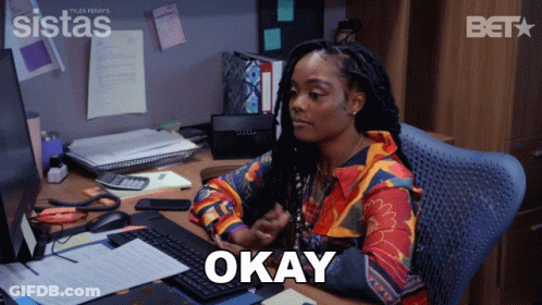 Woman Sitting At Desk With Okay Screen GIF