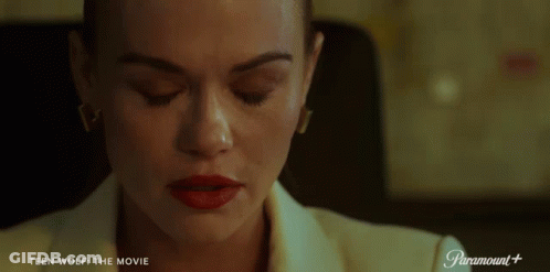 Woman Sitting At Desk With Paramount Logo GIF