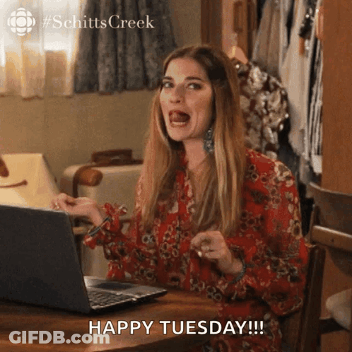 Woman Sitting At Laptop Saying Happy Tuesday GIF