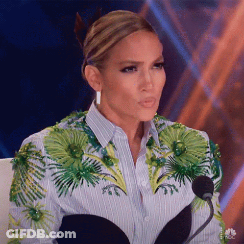 Woman Sitting At Microphone In Striped Shirt With Green Flowers GIF