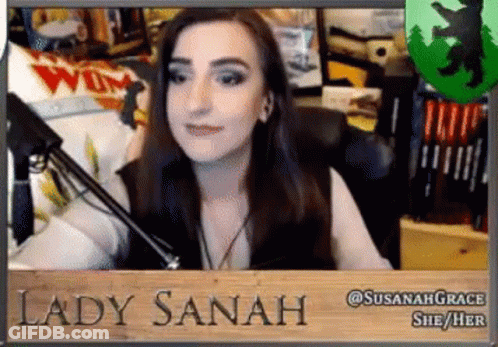Woman Sitting At Microphone With Lady Sanah Sign GIF