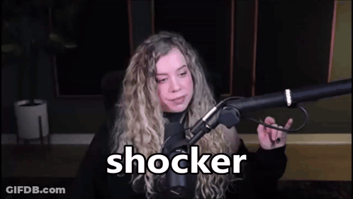 Woman Sitting At Microphone With Shocker On Screen GIF