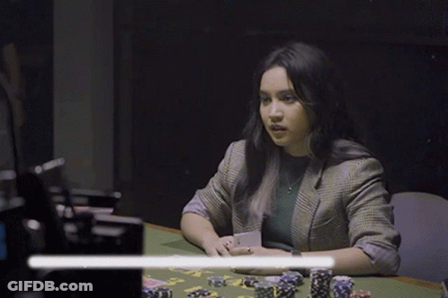 Woman Sitting At Poker Table Holding Card GIF