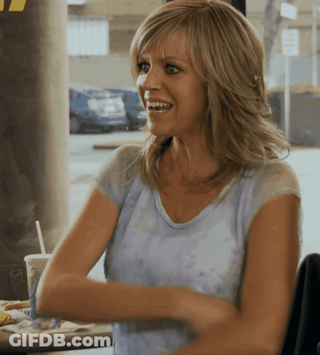 Woman Sitting At Table Arms Crossed Smiling GIF