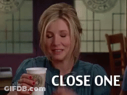 Woman Sitting At Table Holding Coffee GIF