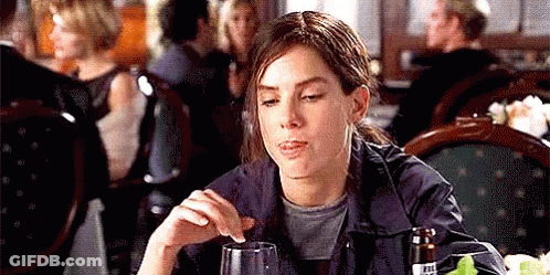 Woman Sitting At Table Holding Glass Of Wine GIF