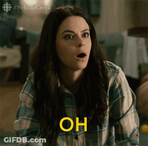 Woman Sitting At Table Holding Paper GIF