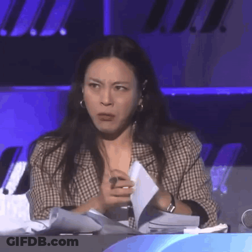 Woman Sitting At Table Holding Paper GIF