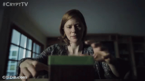 Woman Sitting At Table Looking At Green Box #Crypttv GIF