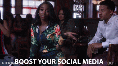 Woman Sitting At Table Saying Boost Your Social Media GIF