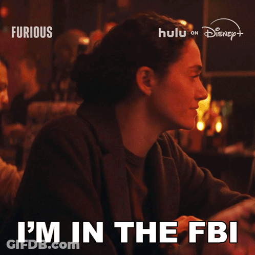 Woman Sitting At Table Saying I'm In The FBI GIF