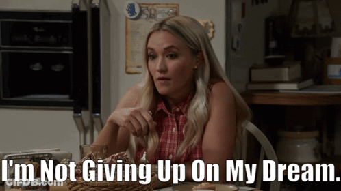 Woman Sitting At Table Saying I'm Not Giving Up On My Dream GIF