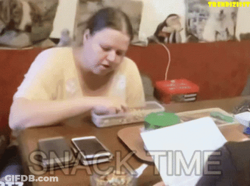 Woman Sitting At Table Saying Snack Time GIF
