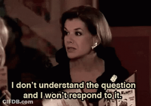 Woman Sitting At Table Talking To Another Woman Holding Menu GIF