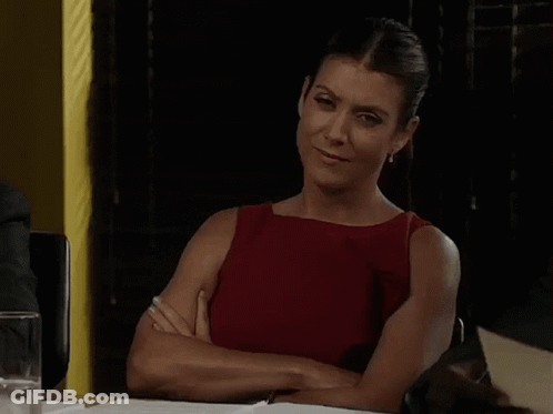Woman Sitting At Table With Arms Crossed GIF