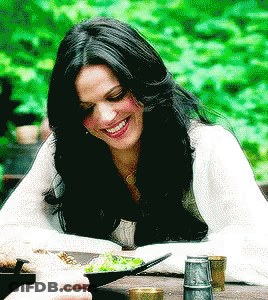 Woman Sitting At Table With Bowl Of Food Smiling GIF