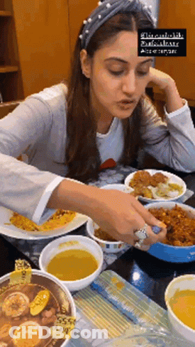 Woman Sitting At Table With Bowls Of Food GIF