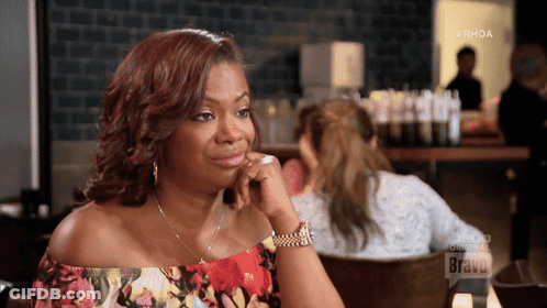 Woman Sitting At Table With Bravo GIF