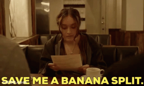 Woman Sitting At Table With Coffee And Paper GIF