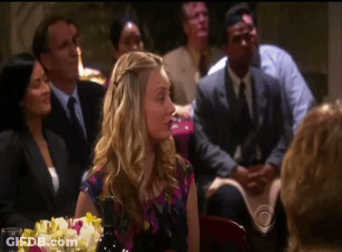 Woman Sitting At Table With Flowers GIF