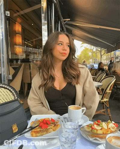 Woman Sitting At Table With Food And Coffee GIF