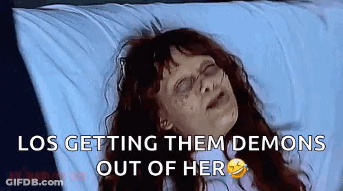Woman Sitting At Table With Glass Of Milk In Mouth Talking To Another Woman GIF