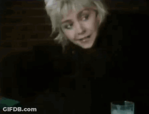 Woman Sitting At Table With Glass Of Water GIF