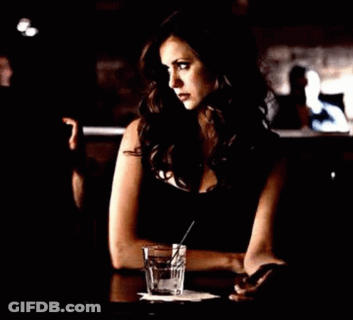 Woman Sitting At Table With Glass Of Water GIF