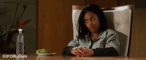 Woman Sitting At Table With Grapes And Water Bottle GIF