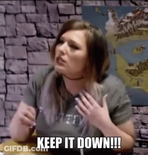 Woman Sitting At Table With Hands On Chest GIF