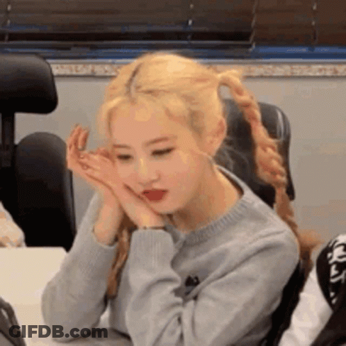 Woman Sitting At Table With Hands On Face GIF