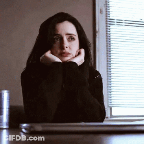 Woman Sitting At Table With Hands On Face And Laptop GIF