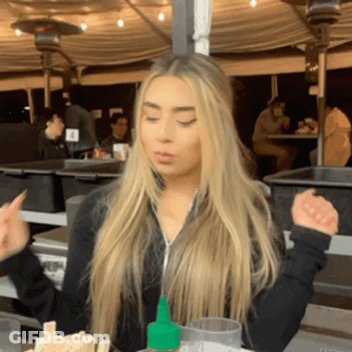Woman Sitting At Table With Hot Sauce Bottle GIF