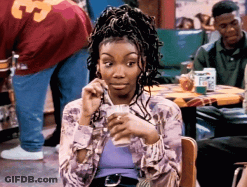 Woman Sitting At Table With Man In 33 Jersey GIF