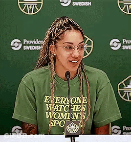 Woman Sitting At Table With Microphone GIF