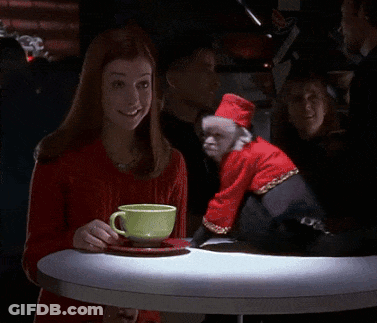 Woman Sitting At Table With Monkey In Santa Outfit GIF