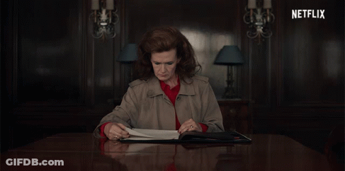 Woman Sitting At Table With Netflix Logo GIF