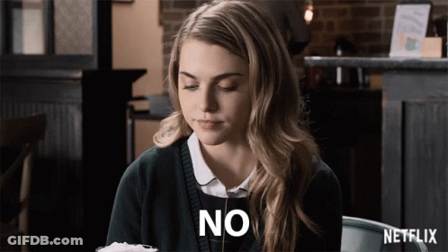 Woman Sitting At Table With Netflix Logo GIF
