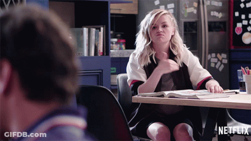Woman Sitting At Table With Netflix Logo GIF