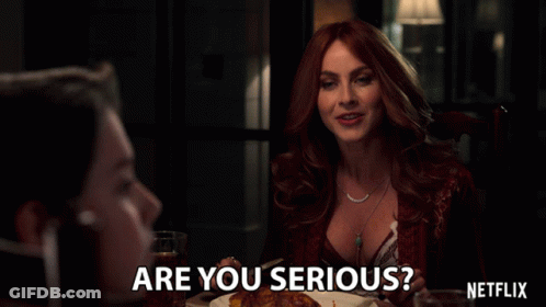 Woman Sitting At Table With Netflix Logo GIF